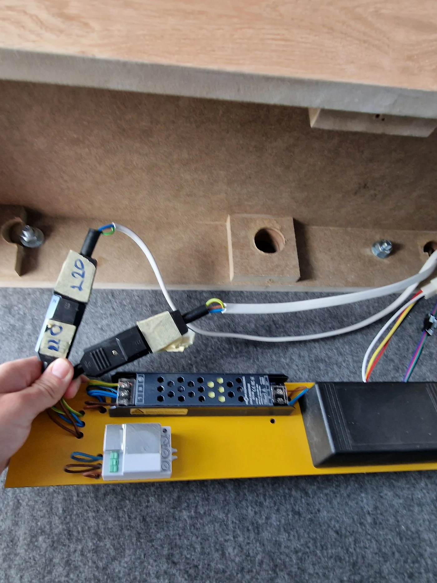 The control electronics of a Silentbox booth — motion sensor, 220V power supply, ceiling module wiring