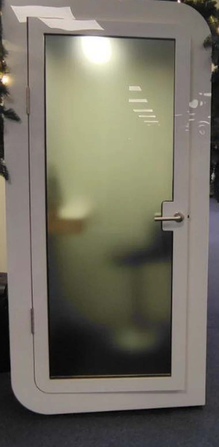 Tinted glass door of a Silentbox acoustic booth